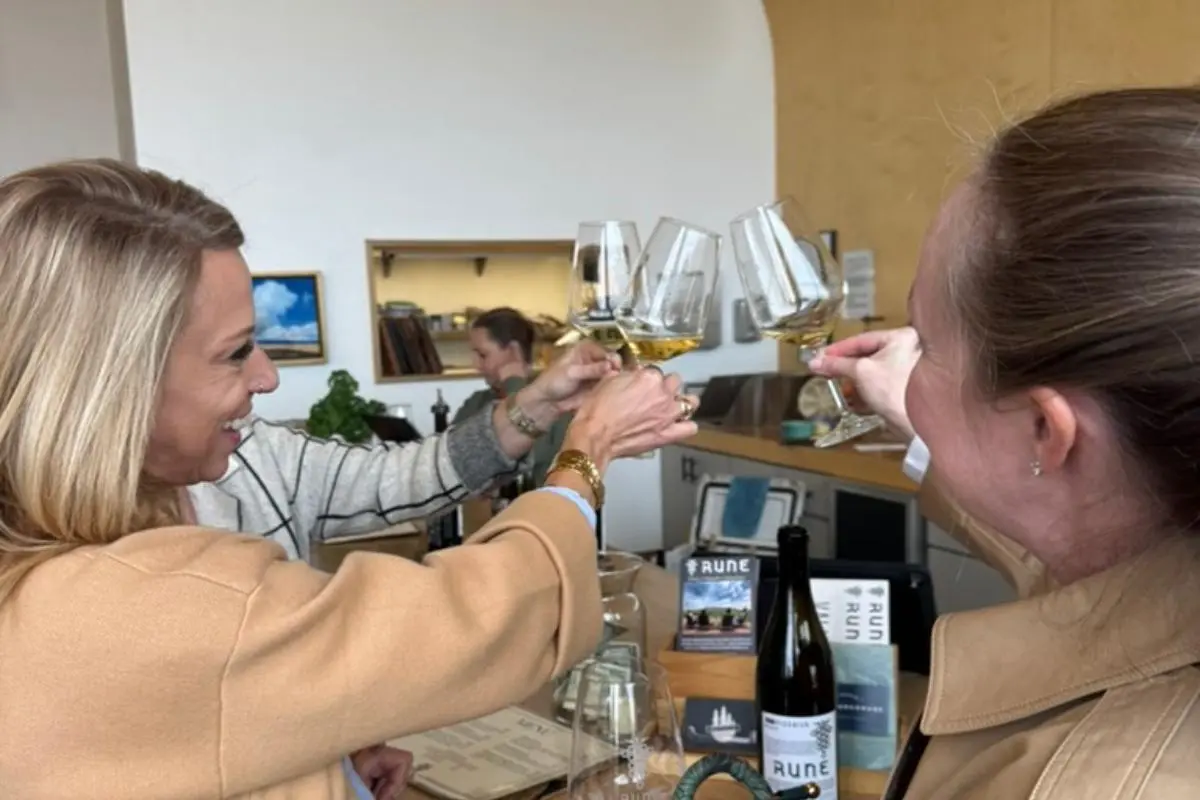 Friends clinking wine glasses while sampling wines at Rune Winery in Sonoita, Arizona